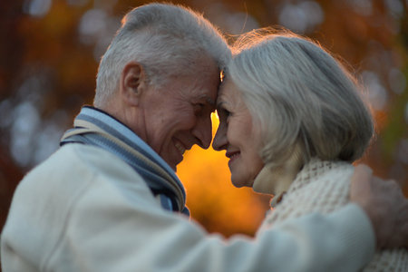 Nice elderly couple in a autumn parkの写真素材