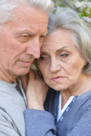 Portrait of sad senior couple in the parkの写真素材