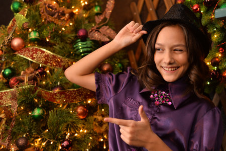 Portrait of little pretty girl near Christmas tree