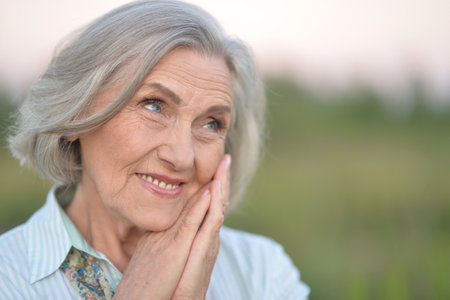 portrait of a happy senior woman in parkの写真素材