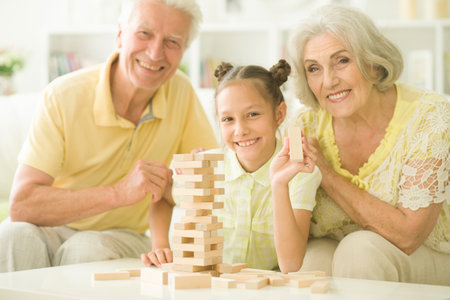 Close up portrait of happy family playing with wooden blocksの写真素材