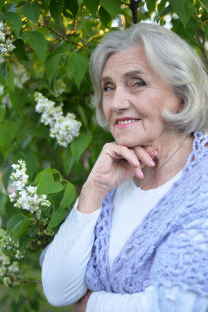 Portrait of senior woman in summer parkの写真素材