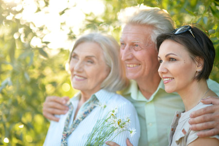 Portrait of happy family posing in summer park