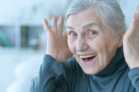 Portrait of happy senior woman posing at home