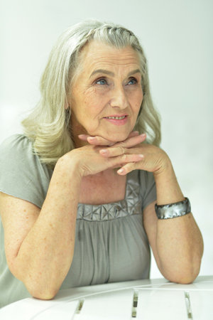 Portrait of happy senior woman posing at home