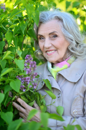 Portrait of a beautiful elderly woman in the parkの写真素材