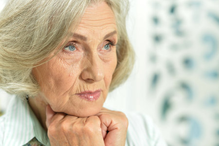 Portrait of an elderly woman posing at homeの写真素材