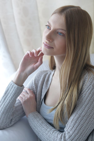 Beauty portrait. Young woman on grey wall background.の写真素材