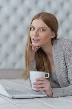Portrait of a happy young girl with laptop computerの写真素材