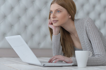 Portrait of a young girl with laptop computerの写真素材