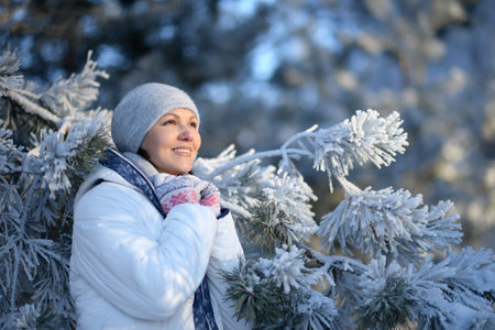 Portrait of beautiful woman posing in winter parkの写真素材
