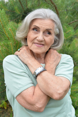 Portrait of a beautiful elderly woman in the parkの写真素材