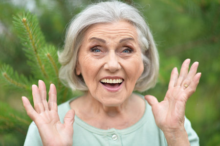 Portrait of a beautiful elderly woman in the parkの写真素材