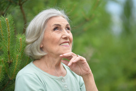 Portrait of a beautiful elderly woman in the parkの写真素材