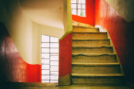 Concrete spiral staircase with red and white walls and transparent glass windows. San Paolo. Brazil....