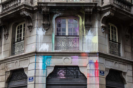 Facade of aged polluted building with red, green, yellow, purple and pink spots.の写真素材