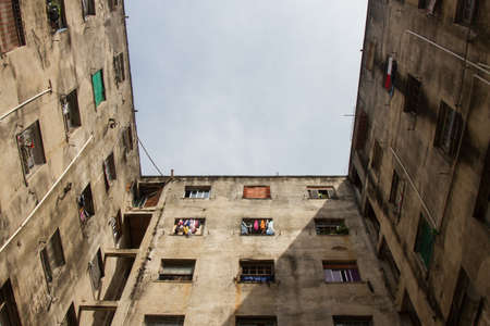 Low angle view of a ruined c shape building with square windows used by social housing movement as home for poor people. San Paolo. Brazil. South America. No people.の写真素材