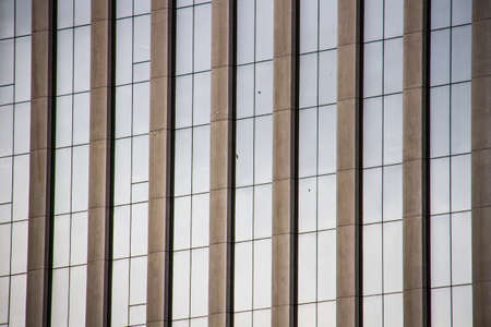 Detail of modern architecture glass windows with concrete columns of a corporate buildingの写真素材