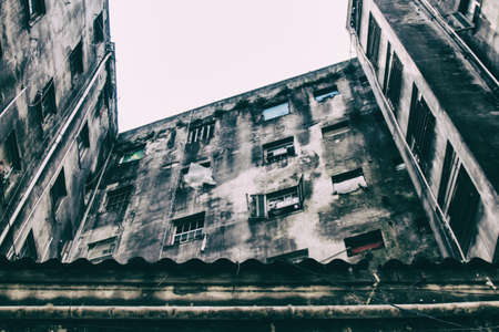 An abandoned building now occupied by social housing movement with white sky on the background. Internal view of the complex in C shape of this timeworn construction. San Paolo, Brazil, South America.の写真素材