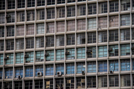 Old business building colored by red, green and blue blindsの写真素材