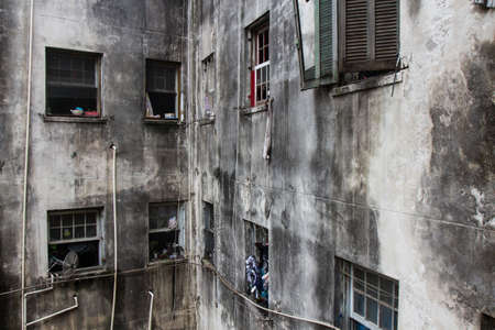 A ruined abandoned c shape building with square windows in San Paolo, Brazil, used as slum by a social housing movement. No people.の写真素材
