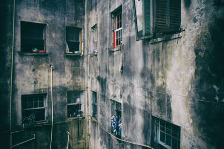 A ruined abandoned c shape building with square windows in San Paolo, Brazil, used as slum by a social housing movement. No people.の写真素材