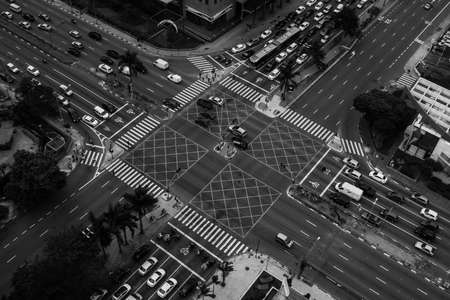 Metropolis crossroads in black and white viewed from a high building.