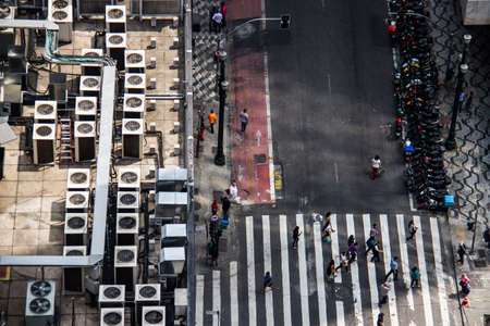 Downtown street and commercial building with air conditioner machinery on the roof viewed from high.の写真素材
