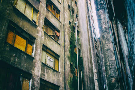 Aged and musty walls of an abandoned building occupied by social housing movement.の写真素材