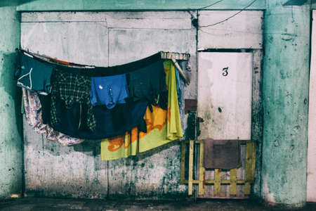 Clothes hanged to dry outside of a home in a dilapidated occupied building by a social housing movement.の写真素材