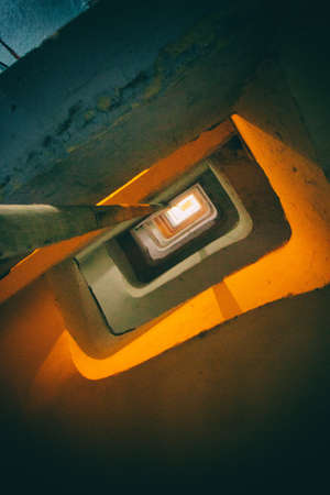 Spiral decayed stairs in a cracked building with 27 floors.の写真素材