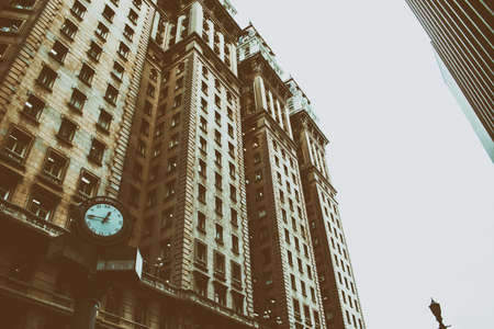 Aged image style of an old classic office building with a clock in frontの写真素材