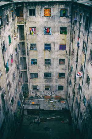 A ruined abandoned c shape building with square windows in San Paolo, Brazil, used as slum by a social housing movement. No people.の写真素材