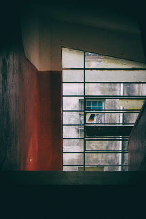 Concrete spiral staircase with red and white walls and transparent glass windows. San Paolo. Brazil....