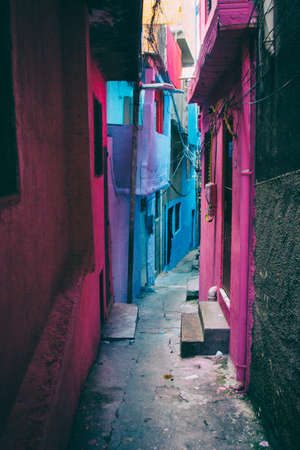An alley with houses in Heliopolis, the biggest favela in San Paulo, Brazil, colored in blue, pink, purple and grey.の写真素材
