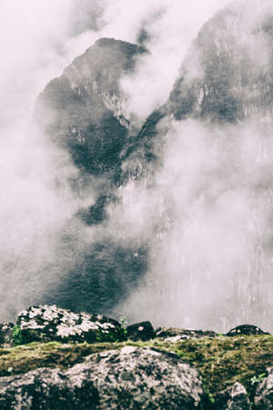 View from the top of a mountain of intense low clouds covering the Andes peaks on the background along the Inca Trail. Vertical Image. No people. Peru.の写真素材