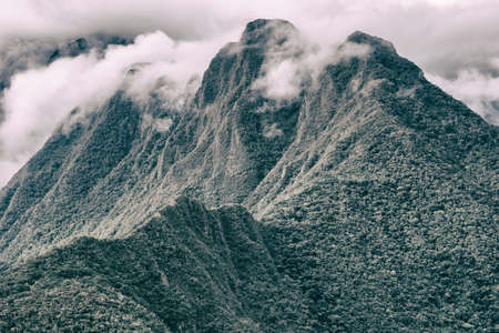 Beautiful wallpaper of the green Andes mountains with clouds above the peak on the Inca Trail to Machu Picchu in Peru.の写真素材