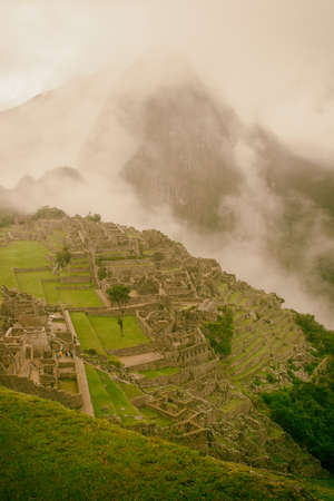 The day start with intense mist in the air in Machu Picchu. The historic archaeological site in a mysterious ambience.の写真素材