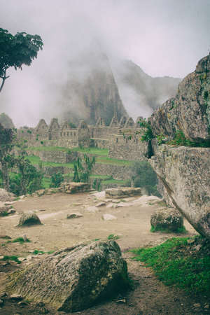 Vertical view of Machu Picchu stone ruins lost in the wild nature of the Andes mountains. Peru. South America. No people.の写真素材
