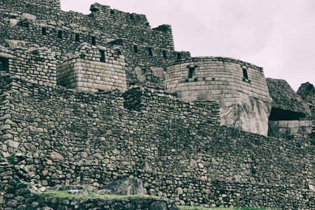 Stone magical ancient ruins along the paved path Inca Trail to Machu Picchu in Peru.