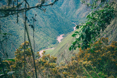 A red water river in the valley surrounded by the wild nature of the Andes mountains seen from the Inca Trail. Peru. South America. No people.の写真素材