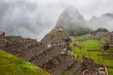 The day start with intense mist in the air in Machu Picchu. The historic archaeological site in a mysterious ambience.の写真素材