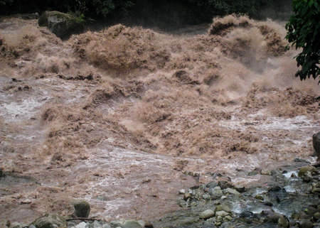 Urubamba River water flow near Ollantaytambo village in the Sacred Valley, region with massive Inca...