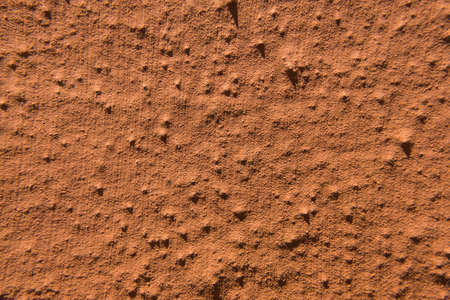 Worn old rough concrete wall with orange peeling paint. Beautiful grunge wallpaper background texture. No people.の写真素材
