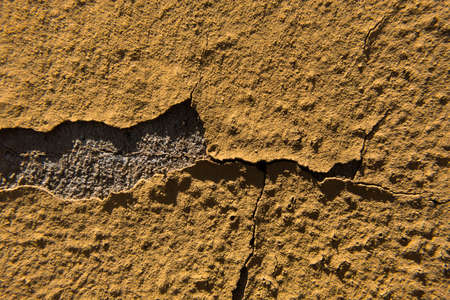 Worn old rough concrete wall with orange peeling paint. Beautiful grunge wallpaper background...