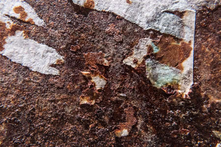 Worn rusty metal surface with pieces of old torn paper. Background texture. Perfect grunge...