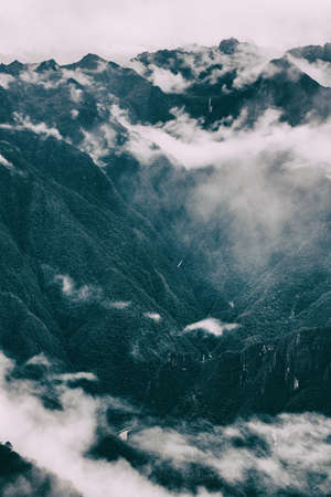 Panoramic inspirational view of the Andes mountains in mist on the Inca Trail. Peru. South America....