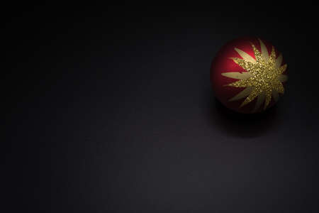 Christmas wallpaper background of red and golden celebration tree ball isolated on black background.の写真素材