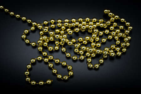 Wallpaper background of gold Christmas decoration object isolated on black background.の写真素材