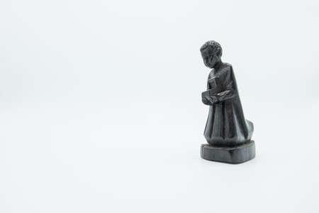 Dark wood Christian nativity scene figures of Biblical Magi isolated on white.の写真素材